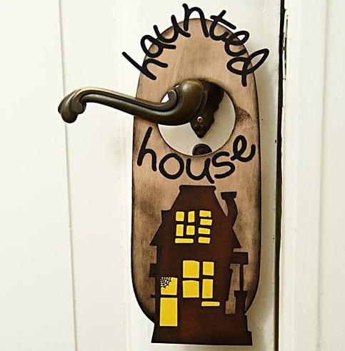 A Haunted House Door Sign