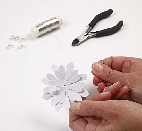 Punched out Daisies with a bead and a clothes peg