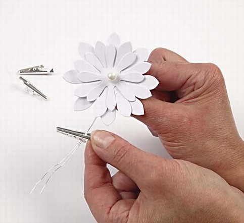 Punched out Daisies with a bead and a clothes peg