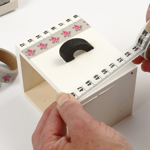 A Wooden Coat Rack with Masking Tape