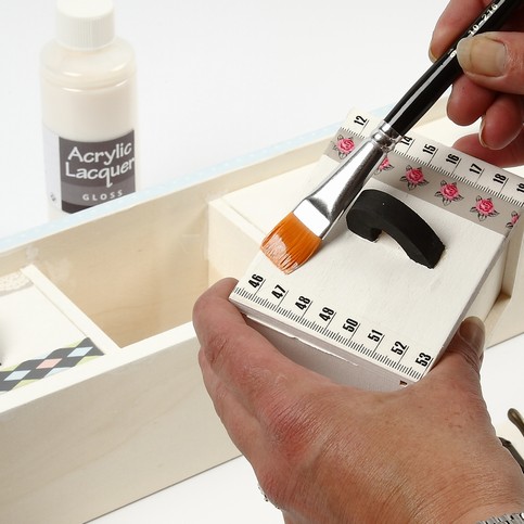 A Wooden Coat Rack with Masking Tape