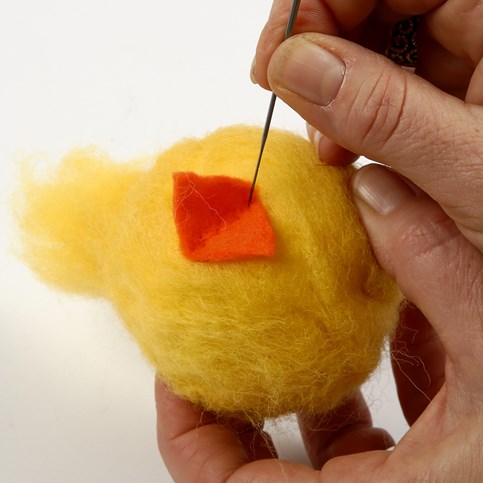 A Needle Felted Chick with Metal Feet and Funny Eyes