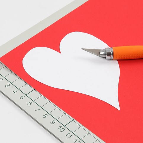 A Valentine Card with Design Paper and a Heart made from red Card