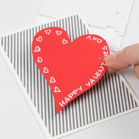 A Valentine Card with Design Paper and a Heart made from red Card