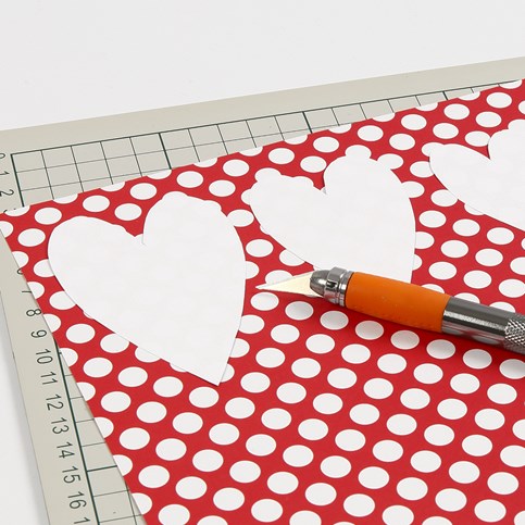 A Valentine Card with a sewn-on Paper Heart and stamped Text