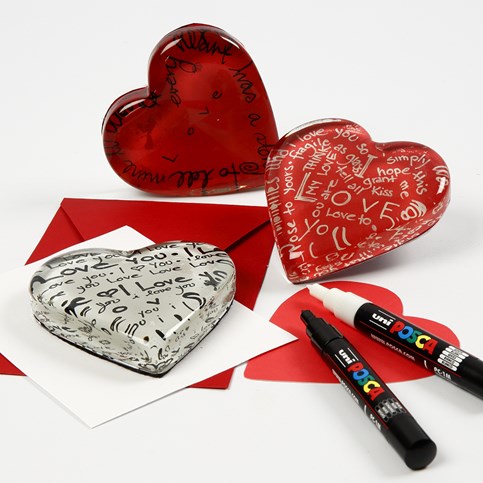 A transparent Glass Heart with a Card Decoration underneath