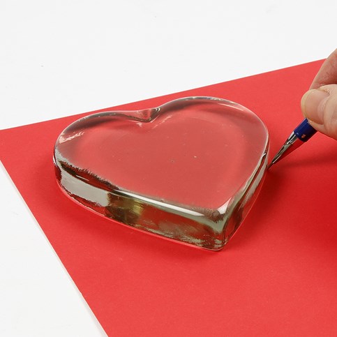 A transparent Glass Heart with a Card Decoration underneath