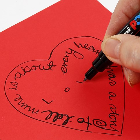 A transparent Glass Heart with a Card Decoration underneath