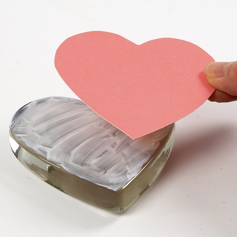 A transparent Glass Heart with a Card Decoration underneath