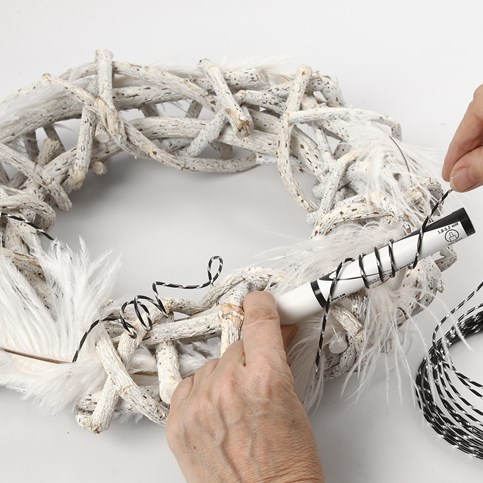 A Wreath made from Branches with Feathers & Goose Eggs with Text