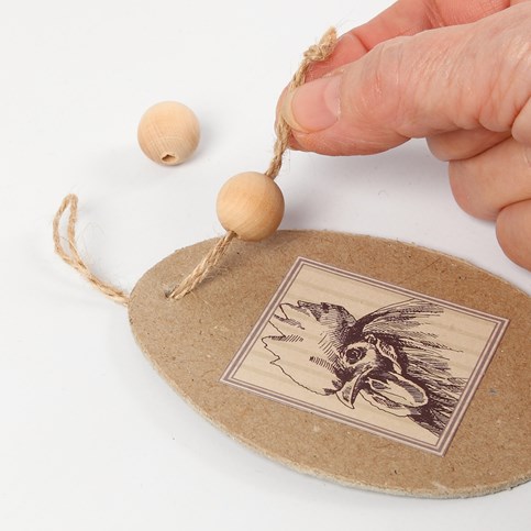 Flat Papier-M ch  Eggs with a Glued-On Motif and Guinea Fowl Feathers