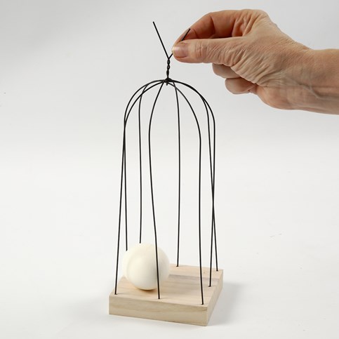 A Bird on a Bird Cage made from Stub Wires on a Wooden Icon Plate