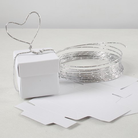 An Invitation and Table Decorations for a White Wedding