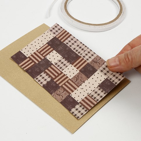 A Christmas Card with a Patchwork made from woven Paper Strips