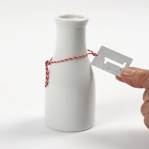 An Advent Candle Holder made from Milk Bottles with numbered Zinc Tags