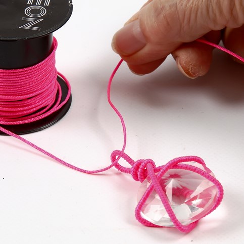 A Necklace with a Prism in a Net made from a Nylon covered Aluminium Bar