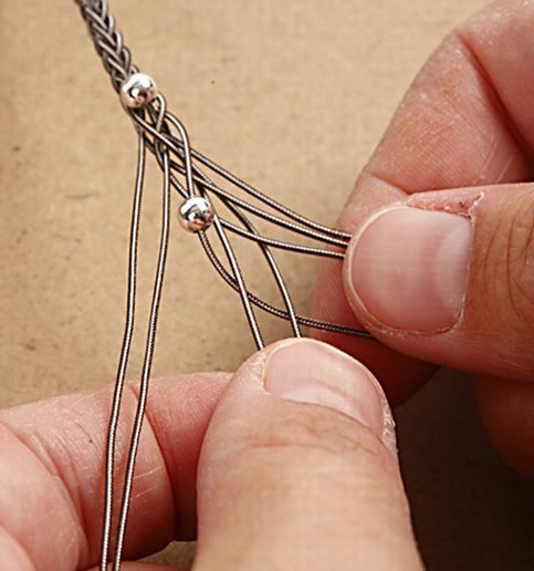 Woven whip bracelet with silver beads